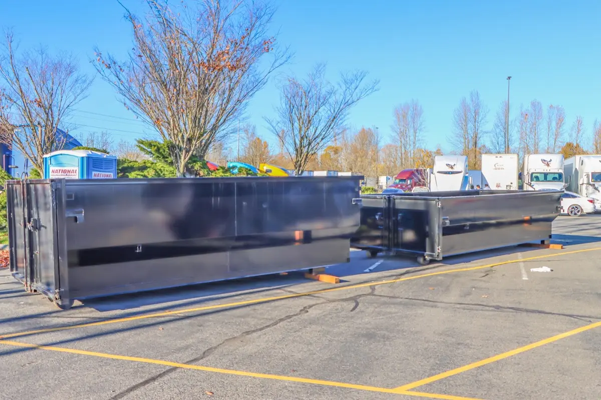 Professional dumpster rental service with roll-off container on residential driveway in Berea